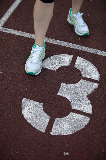 Runner's feet on a track numbered three