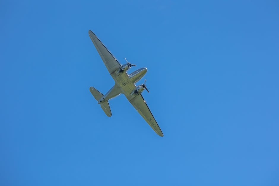 Vintage airplane soaring through clear blue sky representing luxury travel